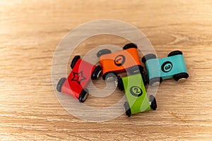Selective focus shot of small flat colorful toy cars with numbers on them on a wooden surface