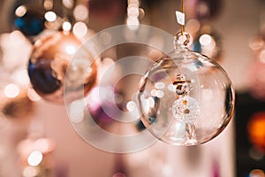 Selective focus shot of a snowman in a clear Christmas ornament, in the Christmas market in Europe