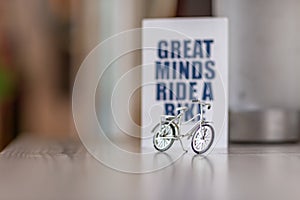 Selective focus shot of a toy bike with a visible message of Great minds ride a bike