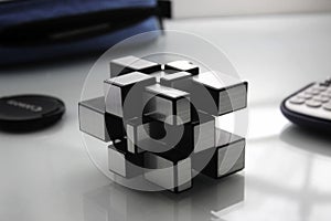 Selective focus shot of an unsolved magic cube on a white desk photo