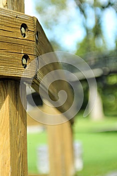 Selective focus shot of a woodpost in a park in the afternoon