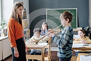 Boy Practicing Trumpet At Music Lesson