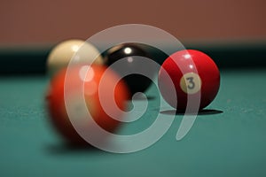 Selective focus shpt of a red billiard ball with the number three