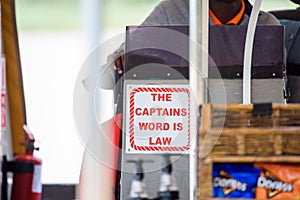 Selective focus of a small board with the text "The Capitals Word is Law" with blurred background