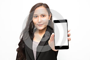 Selective focus of smartphone in asian business woman hand wearing black suit presenting something on white background and copy