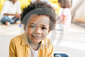 selective focus of smiling african american boy