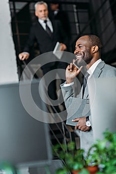 selective focus of smiling african american businessman