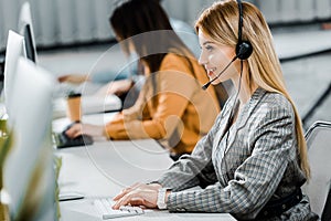 Selective focus of smiling call center operator working