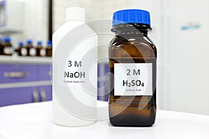 Selective focus of sodium hydroxide base and sulfuric acid solution in brown glass and plastic bottle