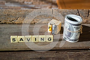 Selective focus of square letters with text SAVING on the table