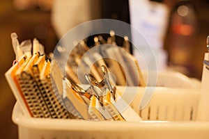 Selective focus stack of bill payment receipt in clipping paper holder tray on cashier register table background in restaurant