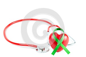 Selective focus Stethoscope,green organ transplant awareness ribbon and red heart on white background.Kidneys cancer .healthcare