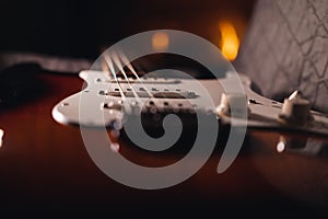 Selective focus of the strings of Stratocaster electric guitar