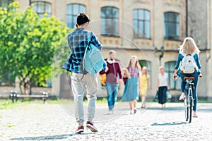 selective focus of students with backpacks