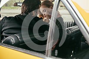 selective focus of stylish young couple in love sitting