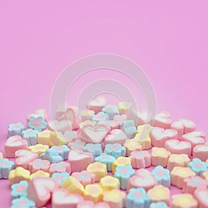 Selective focus of sweet pastel color of marshmallows on pink background