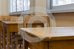 Selective focus on table, Wooden talble and chair in Thailand traditional classroom by nobody in class. Educational concept