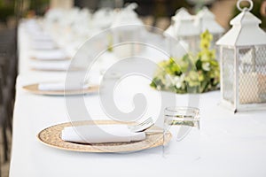 Selective focus of Tableware decorations with white tablecloths at outdoor wedding