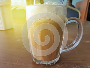 Selective focus of Tea with milk in a mug or popularly known as Teh Tarik in Malay language.