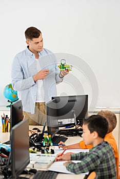 Selective focus of teacher pointing at