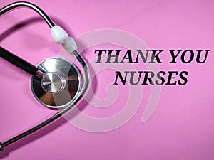 Selective focus.Text THANK YOU NURSES on pink background with stethoscope.Medical concept.