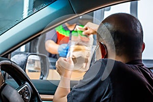 Selective focus to Asian driver buy fast food