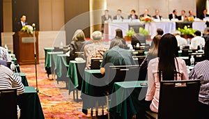 Selective focus to business woman sitting with blurry chairman of the meeting and executive committee background