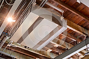 Selective focus to Ceiling mounted cassette type air condition units with other parts of ventilation system with hanging lights