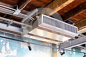 Selective focus to Ceiling mounted cassette type air condition units with other parts of ventilation system with hanging lights