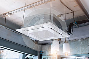 Selective focus to Ceiling mounted cassette type air condition units with other parts of ventilation system with hanging lights