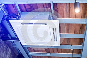 Selective focus to Ceiling mounted cassette type air condition units with other parts of ventilation system with hanging lights