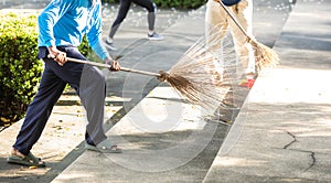 Selective focus to cleaning staff sweeping the floor with a broom