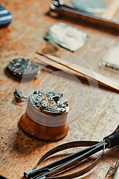 Selective focus to the dismantled mechanism of an old watch
