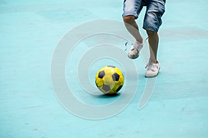 Selective focus to foot of futsal player control the ball for shoot to goal