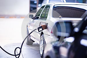 Selective focus to fuel nozzle in gas station. Fill up fuel at gas station