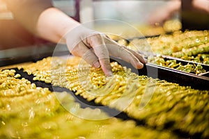 Selective focus to hand is selecting gold jewelry