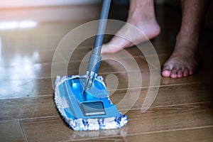 Selective focus to mop to clean floor surface. Cleaning floor with mop. The concept of cleaning service