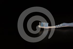 Selective focus on toothbrush isolated on black background