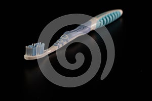 Selective focus on toothbrush isolated on black background