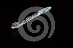 Selective focus on toothbrush isolated on black background