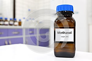 Selective focus of toxic methanol or methyl alcohol in glass bottle inside a laboratory.