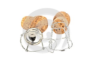 Selective focus of two champagne corks and a muselet separately on a white background