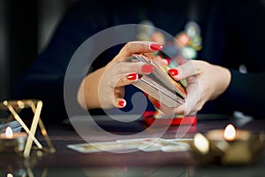 Selective Focus of two hands shuffling and adjusting tarot cards