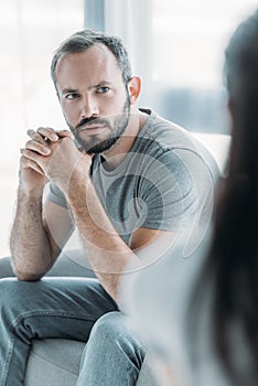 selective focus of upset middle aged man photo