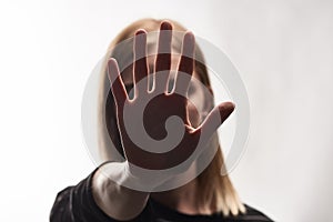 Selective focus of victim of bullying showing stop sign isolated on white.