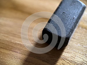 Black rubber eraser on wooden background photo