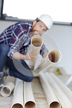 selective-focus view contractor holding plastic tube