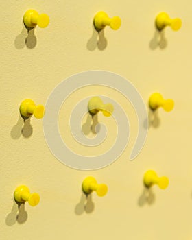 Selective focus view of rows of yellow push pins