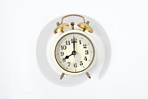 Selective focus vintage alarm clock  with beautiful bouquet flowers  on white background. Love anniversary, dating and present