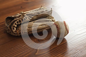 Selective focus vintage baseball and mitt on pine wood background